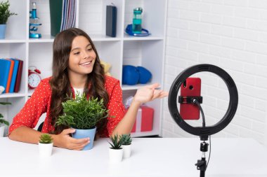 Child vlogger making video blog on phone. Blogging weblog and vlog. Teen girl blogger influencer recording video for social media. Happy girl face, positive and smiling emotions