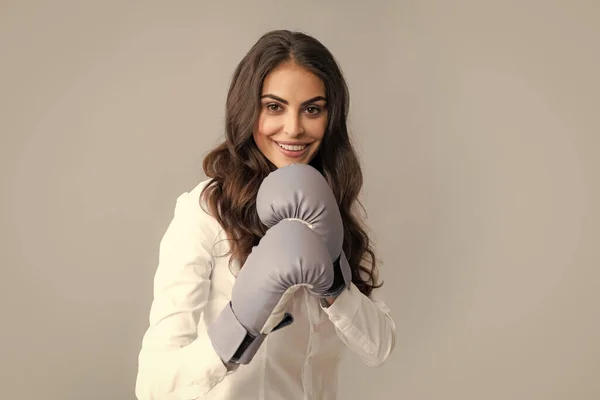 Woman in boxing gloves. Strong happy business woman boss executive concept. Businesswoman wearing boxing gloves ready for the competition