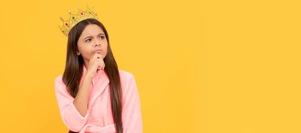 selfish thoughtful teen girl in home terry bathrobe and princess crown, ego. Child queen princess in crown horizontal poster design. Banner header, copy space