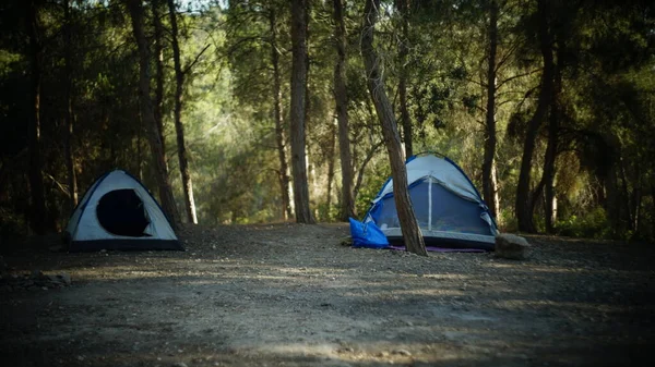 a large tent on a forest camping on the river