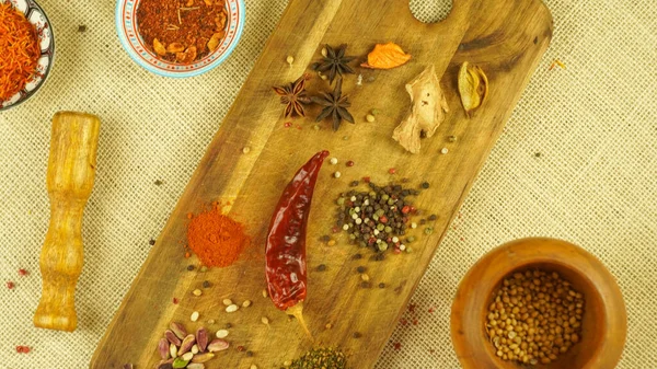 condiments and spices hot peppers saffron cloves and nuts. rustic farmhouse style mortar. ingredients for cooking.