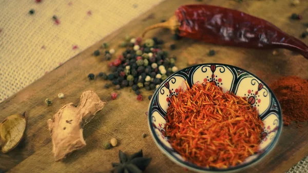 condiments and spices hot peppers saffron cloves and nuts. rustic farmhouse style mortar. ingredients for cooking.