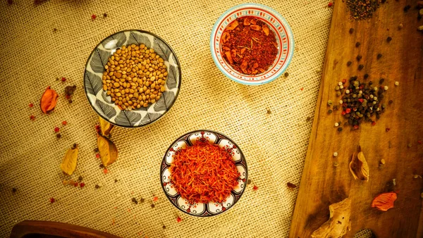 condiments and spices hot peppers saffron cloves and nuts. rustic farmhouse style mortar. ingredients for cooking.