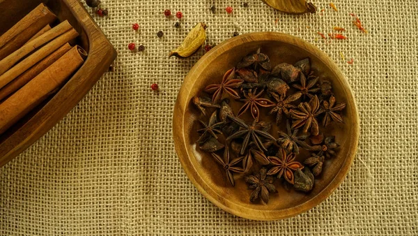 condiments and spices hot peppers saffron cloves and nuts. rustic farmhouse style mortar. ingredients for cooking.