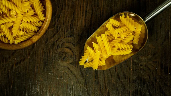 pasta in a dish dry appetizing spiral macaroni in the kitchen food preparation