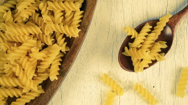 pasta in a dish dry appetizing spiral macaroni in the kitchen food preparation