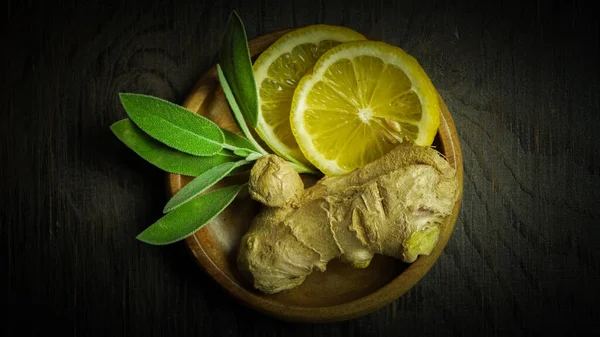 Ginger tea ingredients ginger lemon cinnamon clove saffron sage rustic close-up