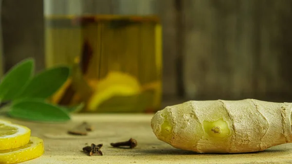 Ginger tea ingredients ginger lemon cinnamon clove saffron sage rustic close-up