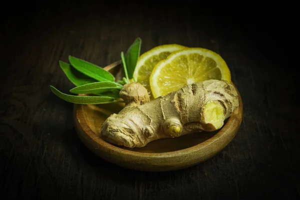 Ginger tea ingredients ginger lemon cinnamon clove saffron sage rustic close-up