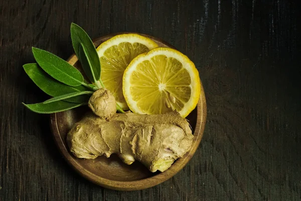 Ginger tea ingredients ginger lemon cinnamon clove saffron sage rustic close-up