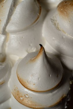 close up of the perfect meringue cones are observed. They are from the delicious lemon pie cake.