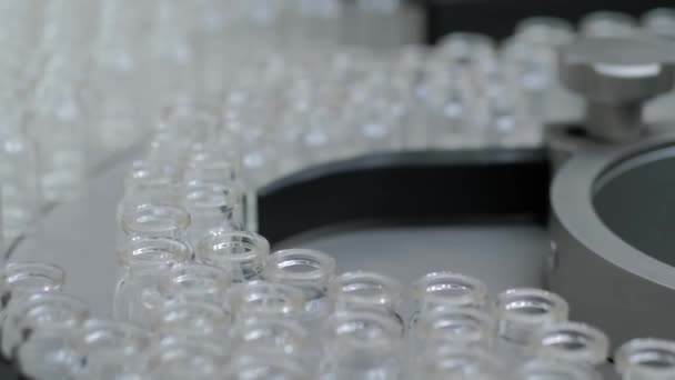 Conveyor belt with empty medical injection glass vials - production line — Stock Video