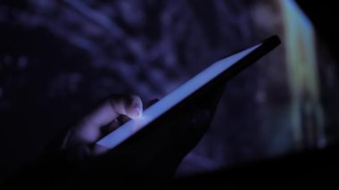 Sergide renkli ışıklandırmalı akıllı telefon kullanan kadın - yakın çekim
