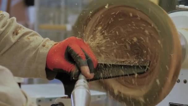 Carpenter using chisel for shaping piece of wood on lathe with sawdust - slow mo — Stock Video