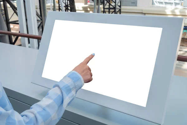 Woman hand touching interactive white touchscreen display kiosk: close up