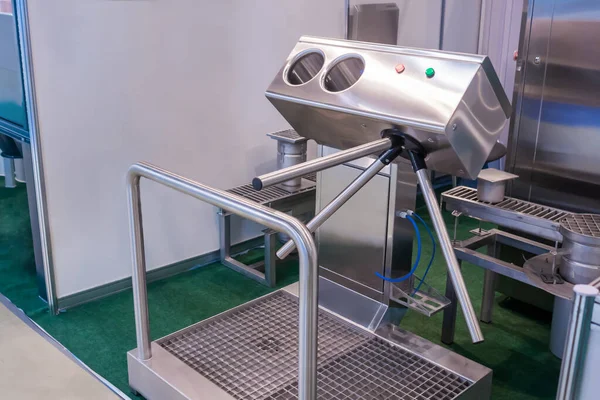 Hand hygiene station with turnstile gate before entering production area