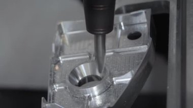 Automated cnc turning milling machine cutting metal workpiece: close up