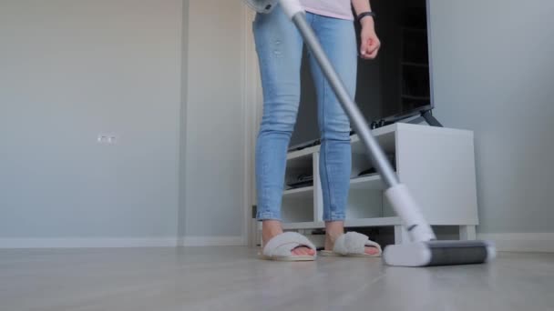 Woman cleaning living room with modern upright vacuum cleaner — Stock Video