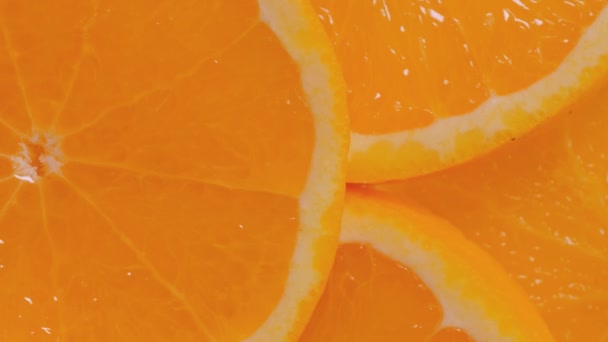 Pohled shora: čerstvé plátky pomeranče citrusových plodů na otočném povrchu - zblízka — Stock video