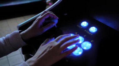 Retro arcade makine oyunu oynayan kadın oyuncu ve parlak düğmelere basarak
