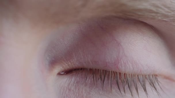 Man opening and closing his eye, looking at camera - extreme close up, macro — Stock Video