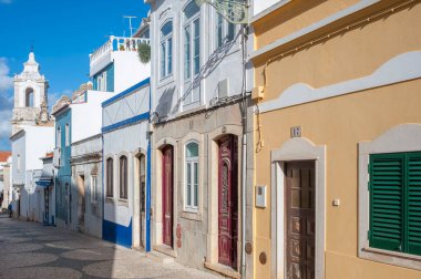 Old town alley Rua de Sao Goncalo in Lagos in the Algarve in Portugal. In the background the Santo Antonio Church