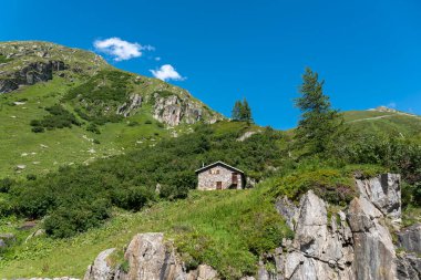 İsviçre, Valais 'teki Ulrichen yakınlarındaki Nufenen Geçidi' nin altındaki Ladstafel köyünün yakınındaki dağlık arazide dağ kulübesi.