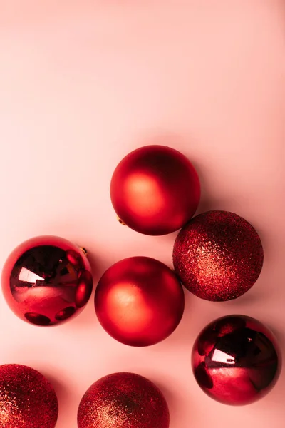 Kırmızı Noel fırfırları ve pembe arka planda yazma alanı olan düz bir yer.