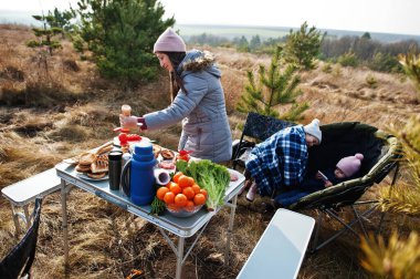 Çam ormanında bir güvertede aile barbeküsü. Izgarayla barbekü günü.