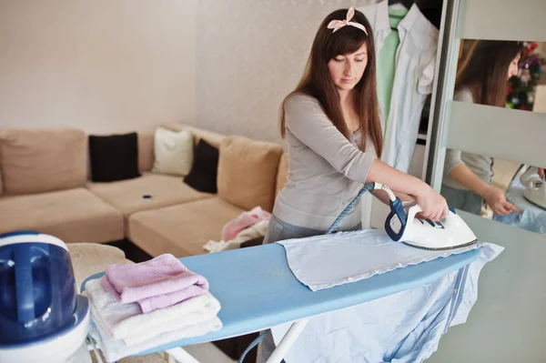 Young Woman Ironing Clothes Home — Fotografia de Stock