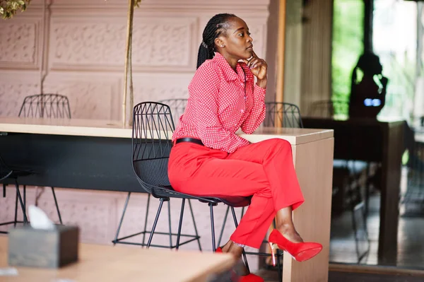 Pretty braids business african american lady bright bossy person friendly wear office red shirt and trousers, sitting on chair.
