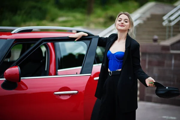 美しいブロンドのセクシーなファッション女性モデルの肖像画でキャップとすべての黒 青のコルセット ともに赤い街の車の近くに明るいメイク — ストック写真