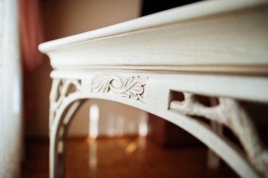 White wooden carved table in flat.