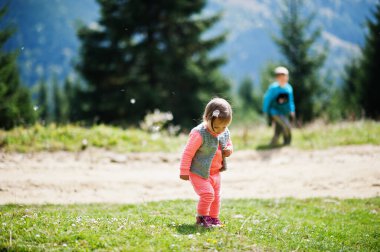 Baby girl with brother travel to nature. Relaxing on the mountain. Feel freedom. 