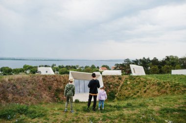 Kids walking against modern futuristic building outdoor.