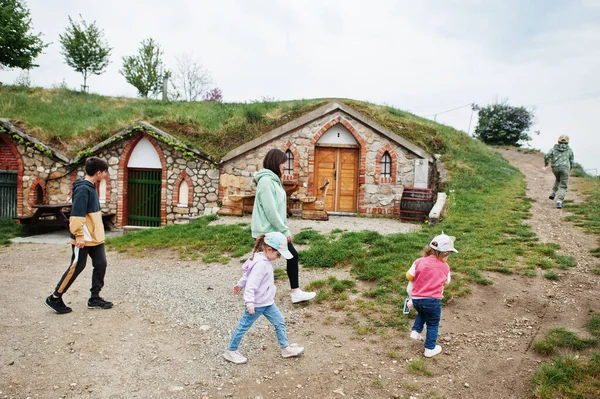 Mother with kids walking near traditional wine cellars outdoor at Vrbice, Czech Republic.