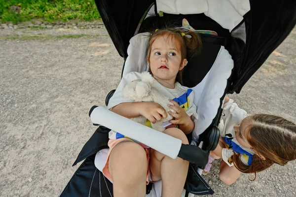 Baby Girl Hold Toy Sister Sitting Stroller — Stock Photo, Image