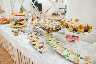 Beautiful wedding candy bar with sweets, fruits and food. Wedding banquet table