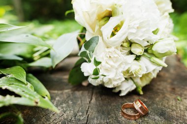 Beautiful tender wedding bouquet and rings. 