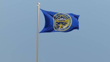 Nebraska flag on flagpole. NE flag fluttering in the wind. USA. National flag.