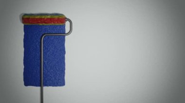 Roller paints the wall in colors of Romanian flag. Travel concept. Romania republic.