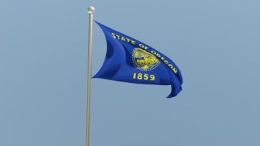Oregon flag on flagpole. OR flag fluttering in the wind. USA. National flag.