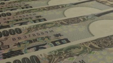 10000 Japanese yen money composition. Financial background. Many banknotes and wads of money. Business or economy concept. Cash.