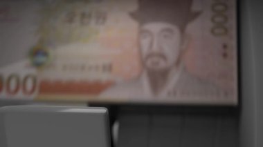 5000 South Korean won in cash dispenser. Withdrawal of cash from an ATM. Financial transaction in the bank terminal. KRW.