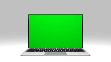 Yeşil ekran görüntülü gri laptop. Reklam için yeri olan bir defter. Kişisel bilgisayarın ekranında Chromakey alanı.