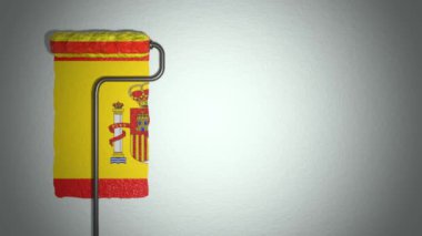 Roller paints the wall in colors of Spain flag. Travel concept.
