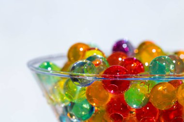 Seçici odaklı yakın plan çekimde renkli jel boncuklar, cam kap, arkaplan veya doku konseptine yerleştirilir