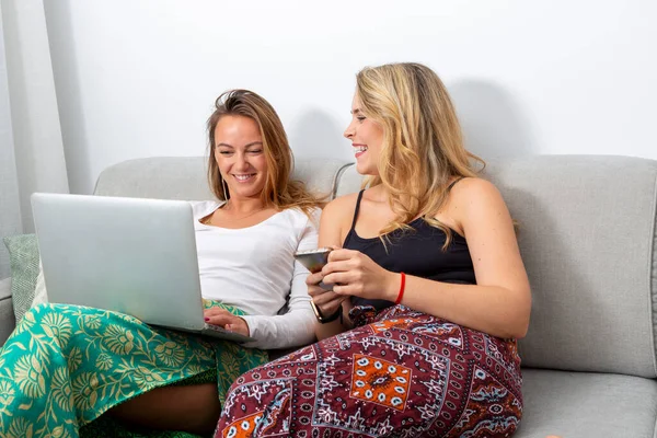 Smiling Lesbian Couple Sofa Looking Laptop Smart Phone — 스톡 사진