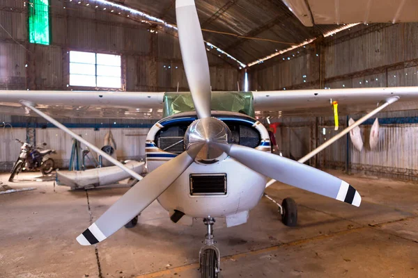 plane frontal inside the hangar