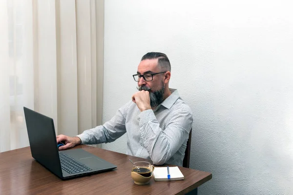 hipster bearded man working with laptop computer at home